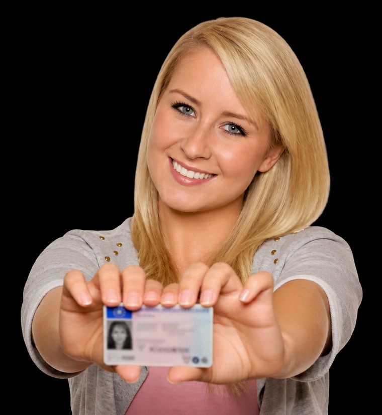 Smiling learner holding out her new driving licence